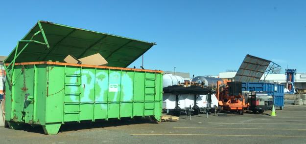 Garbage disposal dumpster out by the snow shed