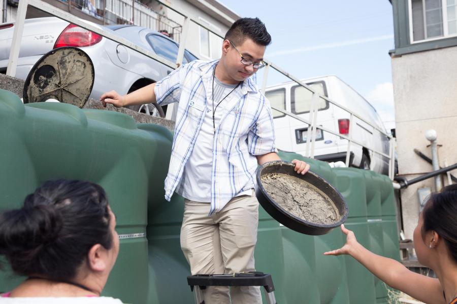 boy holding tray with dirt 