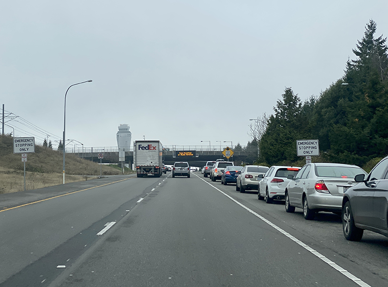 Cars parked on the shoulder of the Airport Expressway