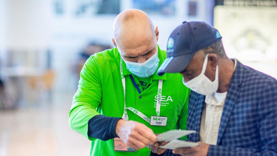 SEA volunteer Joseph Olive helps a passenger.