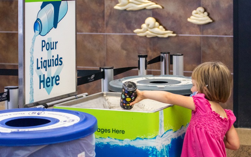 Open bottle and pour liquid into the drain on top of the Liquid Drain Station receptacle.