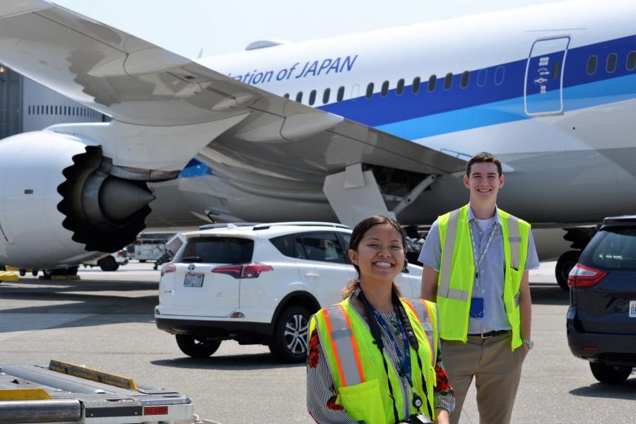 Interns in front of a jet 