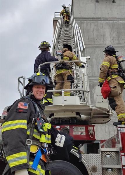 Commissioner Calkins waits as firefighters practice training drills