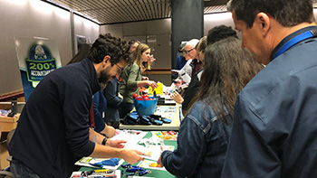 Experts and employees connect across display tables at the Safety Fair