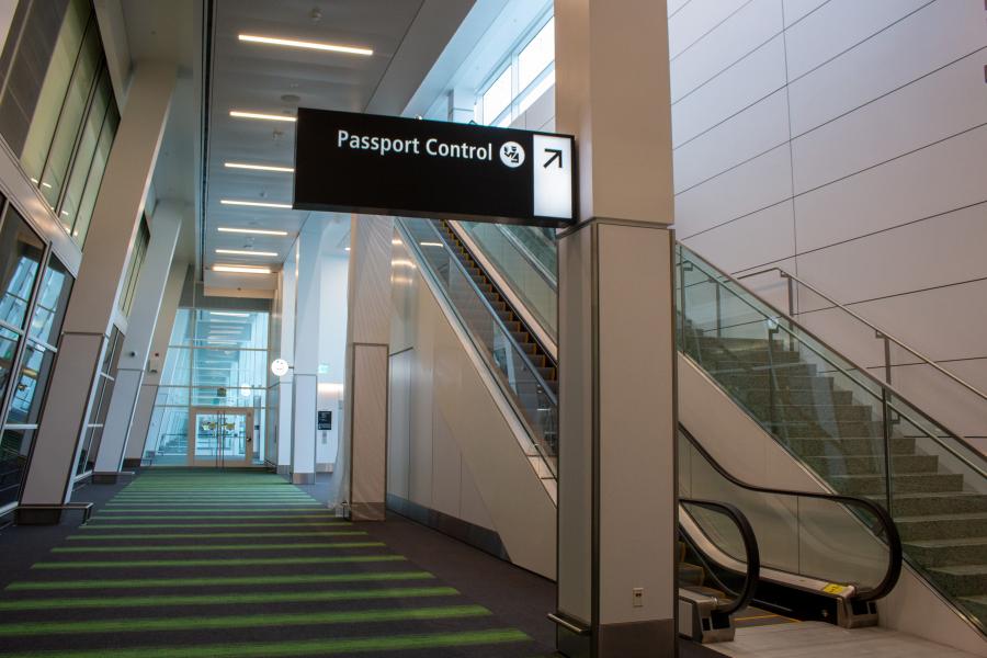 Interior photo of the International Corridor showing the top of the staircase and escalator.