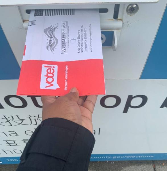 LaTonja puts her ballot in a ballot box