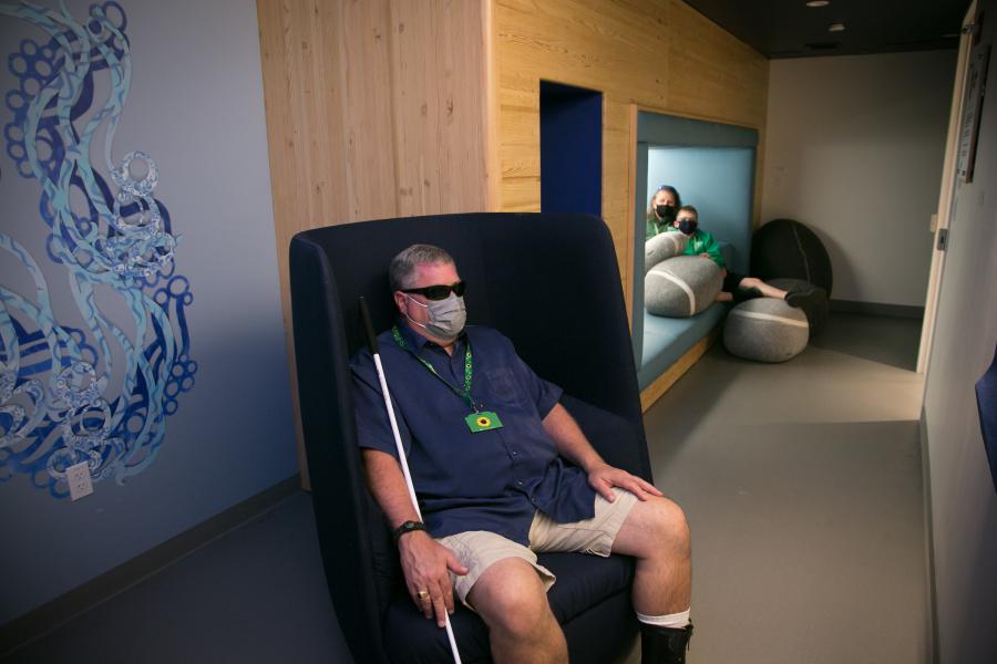 A family of travelers using the sensory room to take a break from the hustle and bustle of the terminal. 