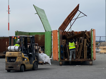 POS staff disposing of wood in designated dumpster