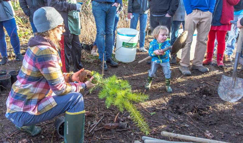 Sophia Cassam planting a tree