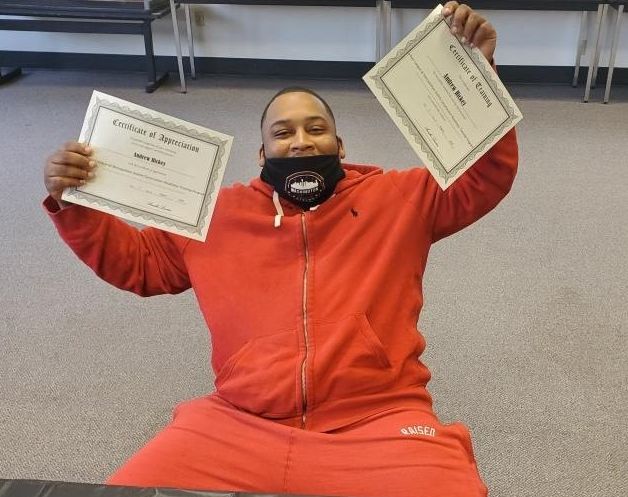 Graduate showing off his certificate