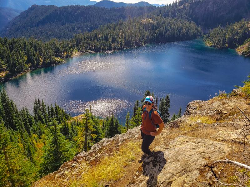 Marissa Pedersen on a hike with a lake in the background