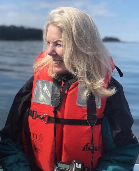 image of Natalie Fobes wearing a life jacket on a boat