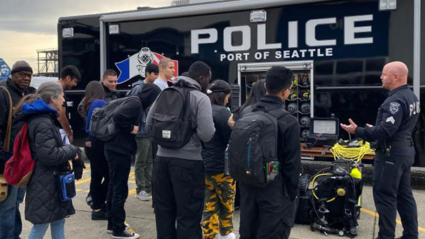 Port police officers give a demo to interested student interns at an intern event, sEA Airport, Summer 2018